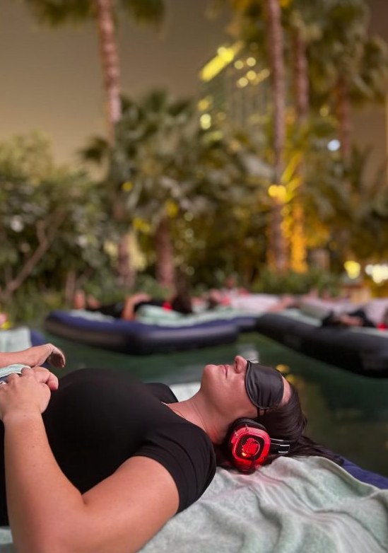 Guest resting with an eye mask and sound-healing headphones